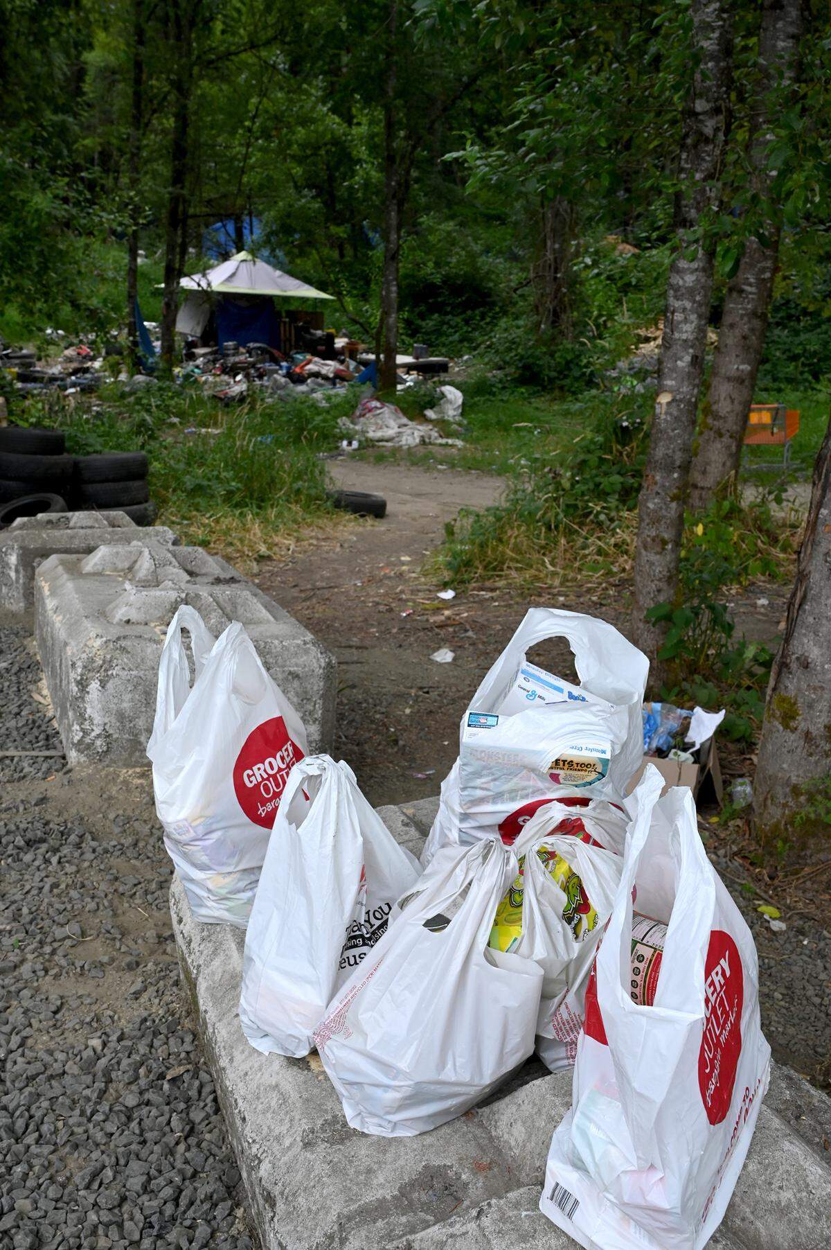  A row of dropped off, donated good  sits ready for camp residents as group representing local elected officials along with Lacey and Olympia city staffs tour the sprawling homeless encampment along Martin. Way East  in the Olympia city limits known as the Jungle”. 