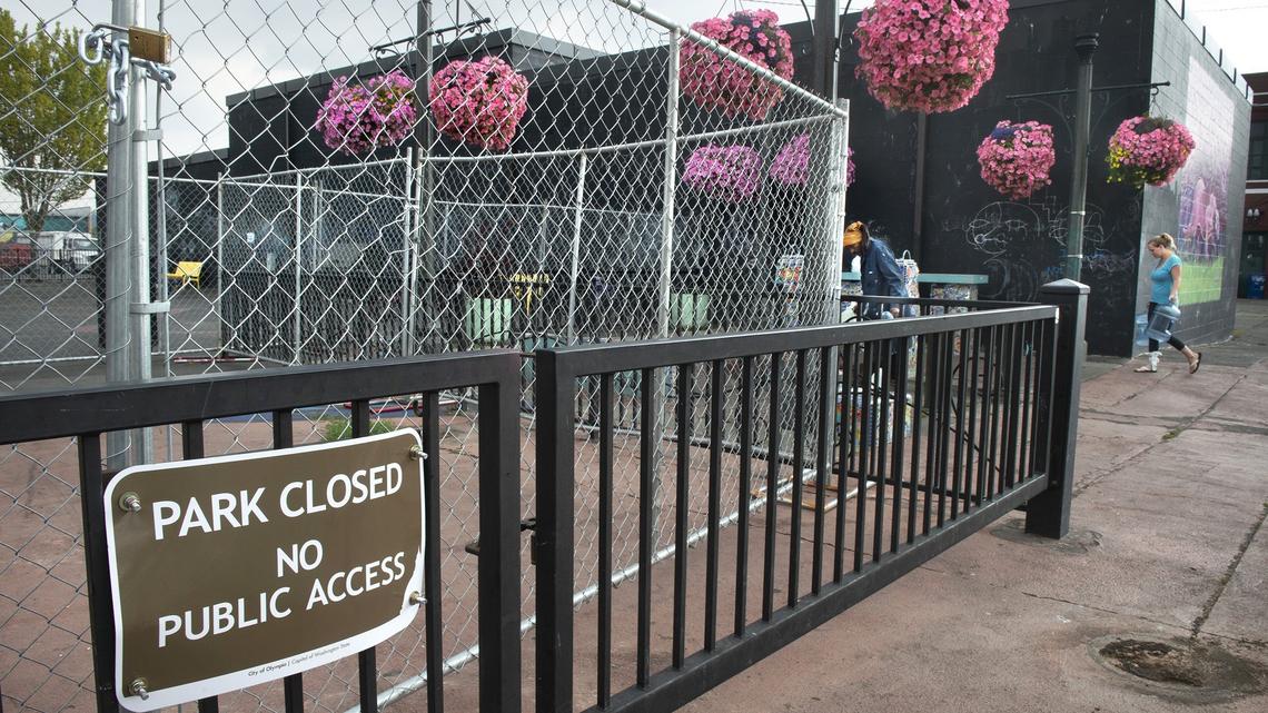 A chain-link fence surrounds the Artesian Commons Park in downtown Olympia on Friday. City officials moved to close the park indefinitely because of threats made to park staff in recent weeks.