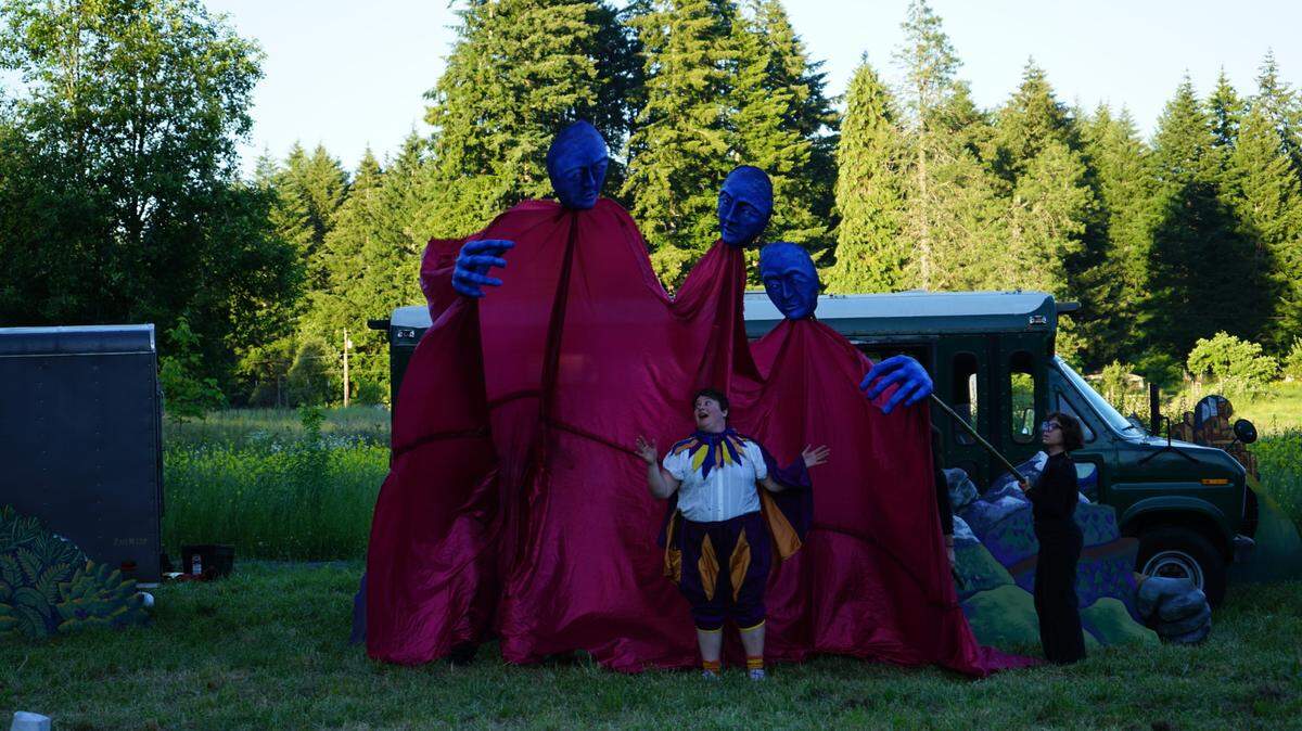 Giant puppets are among the characters in “Far Away and Hard to Find.” Luz Gaxiola plays a bard on a quest to find her tuba.