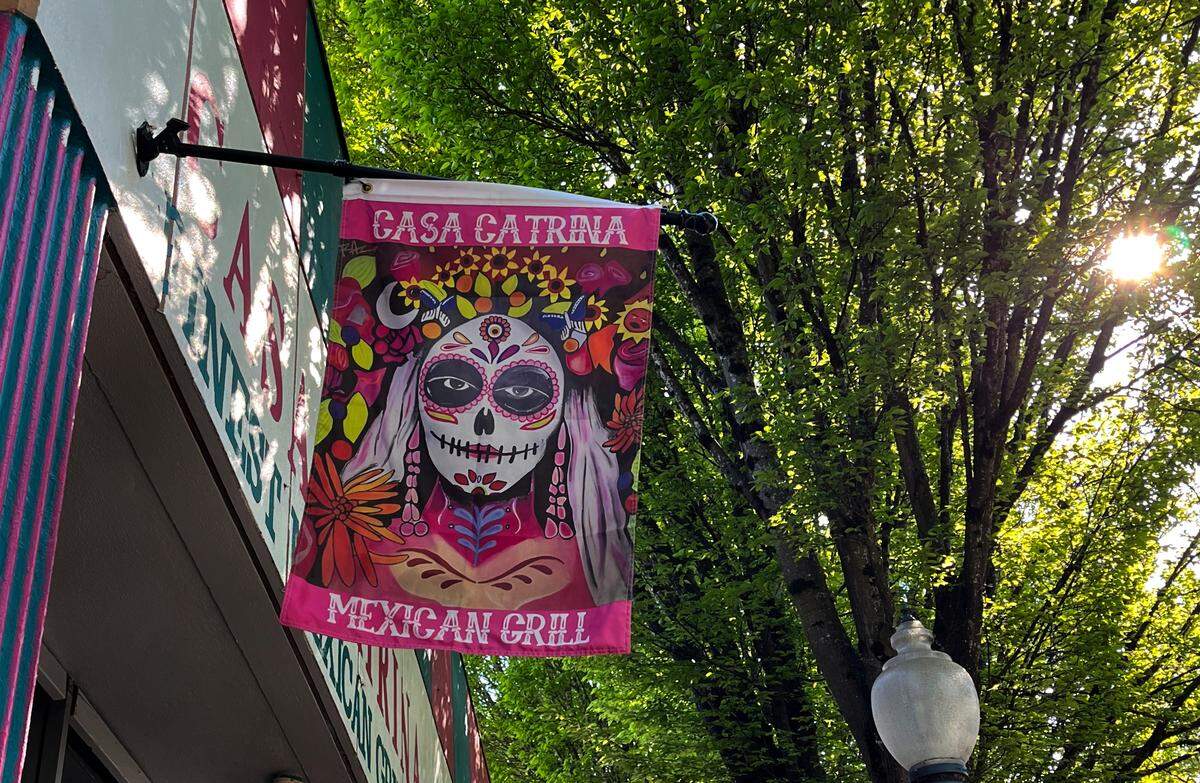 A flag for Casa Catrina hangs over Fourth Avenue between Franklin and Adams streets.