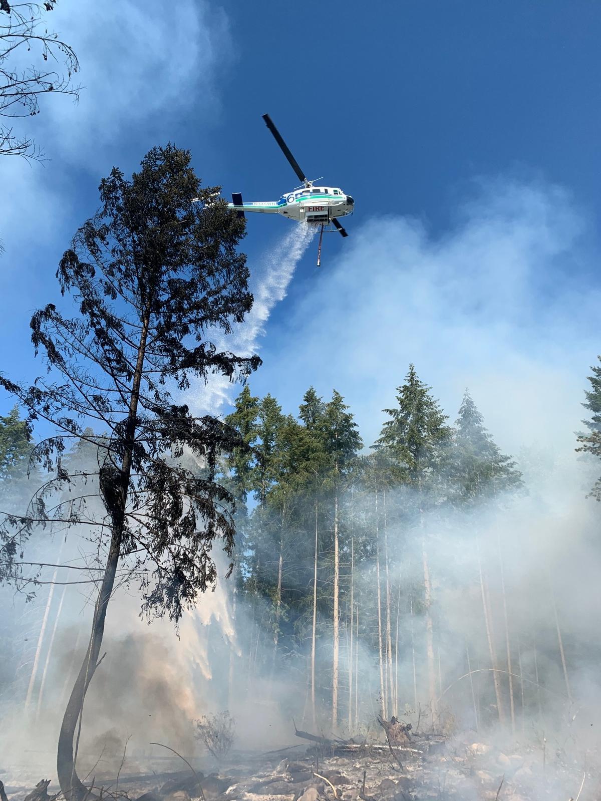 A state Department of Natural Resources helicopter responded to a brush fire in southeast Thurston County Tuesday.