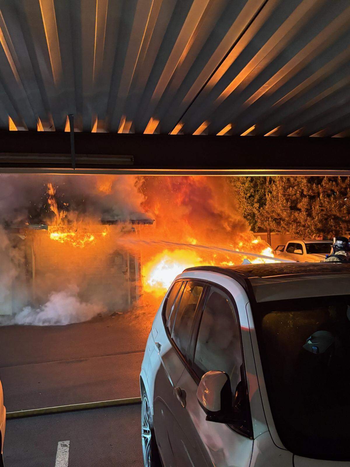 Fire damaged vehicles and garage units at a Puyallup area fire overnight Sunday.