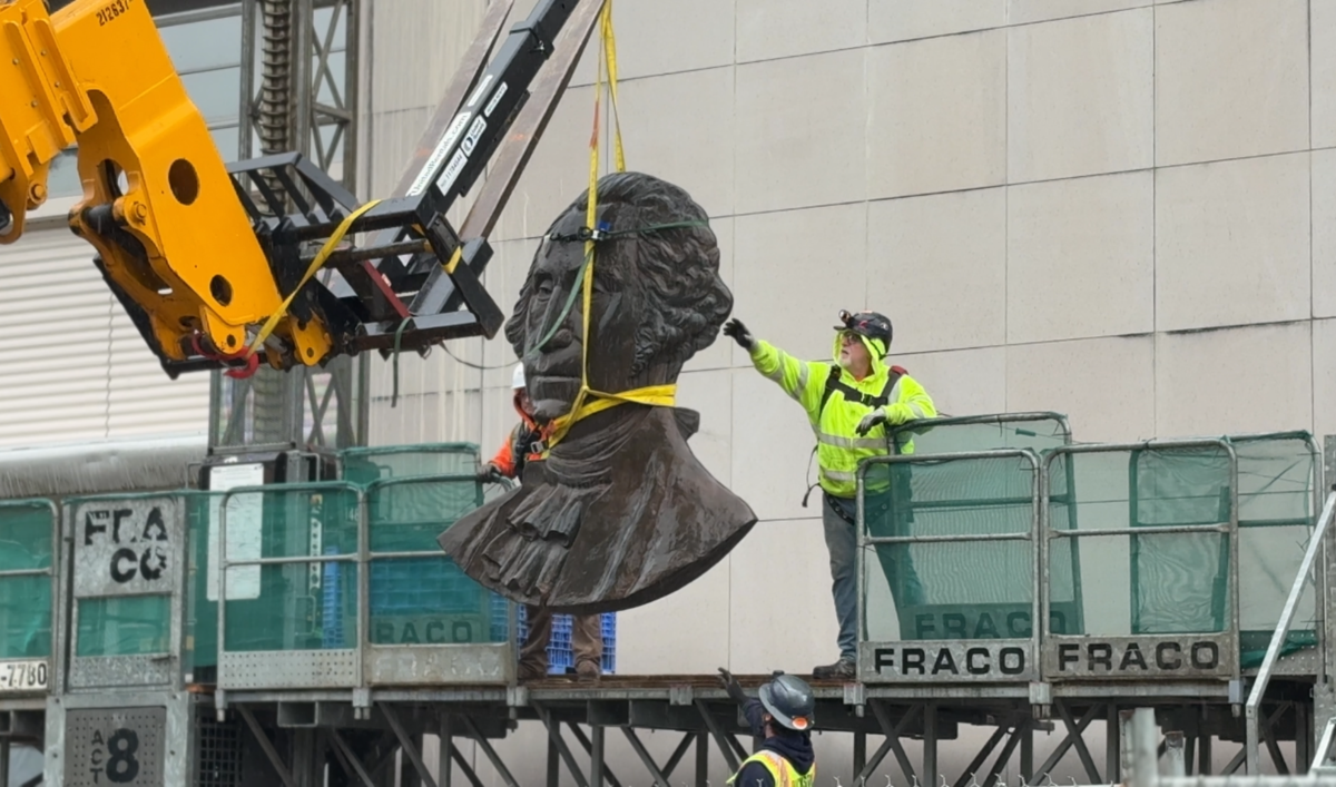 This photo shows the removal of a large state of Washington seal that once hung on the exterior of the General Administration Building in Olympia.