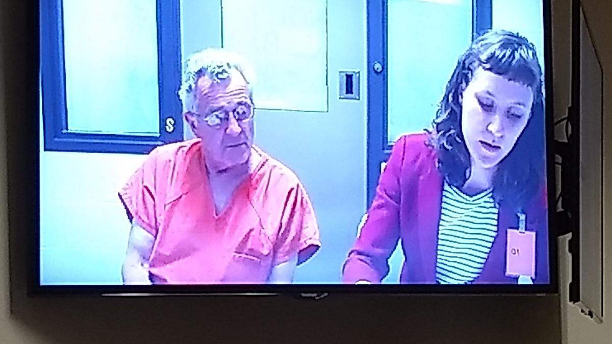 Randall Jerome Burcham appeared in Thurston County Superior Court Friday. He is being held without bail on first-degree murder and attempted first-degree murder charges after his wife was shot dead and his stepson was wounded Thursday.