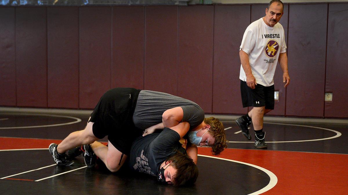 Yelm head wresting coach Gaylord Strand referees a challenge competition between Cael Gendron and Gary Myers during the TornadosÕ May 25 practice.