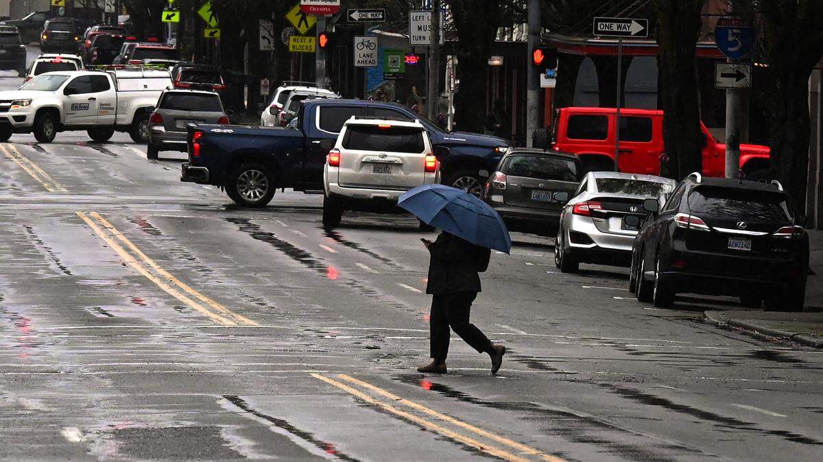 Umbrellas were the preferred fashion for the wet Wednesday in downtown Olympia as steady rains coupled with wind rolled through town while prompting regional flood advisories.