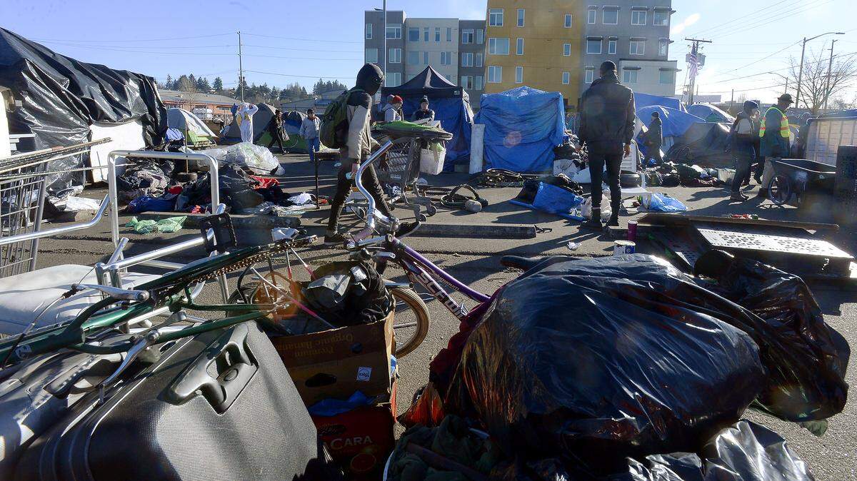 Residents move out of the homeless encampment at the corner of State Ave and Franklin Street Tuesday which was unsanctioned by the city of Olympia.