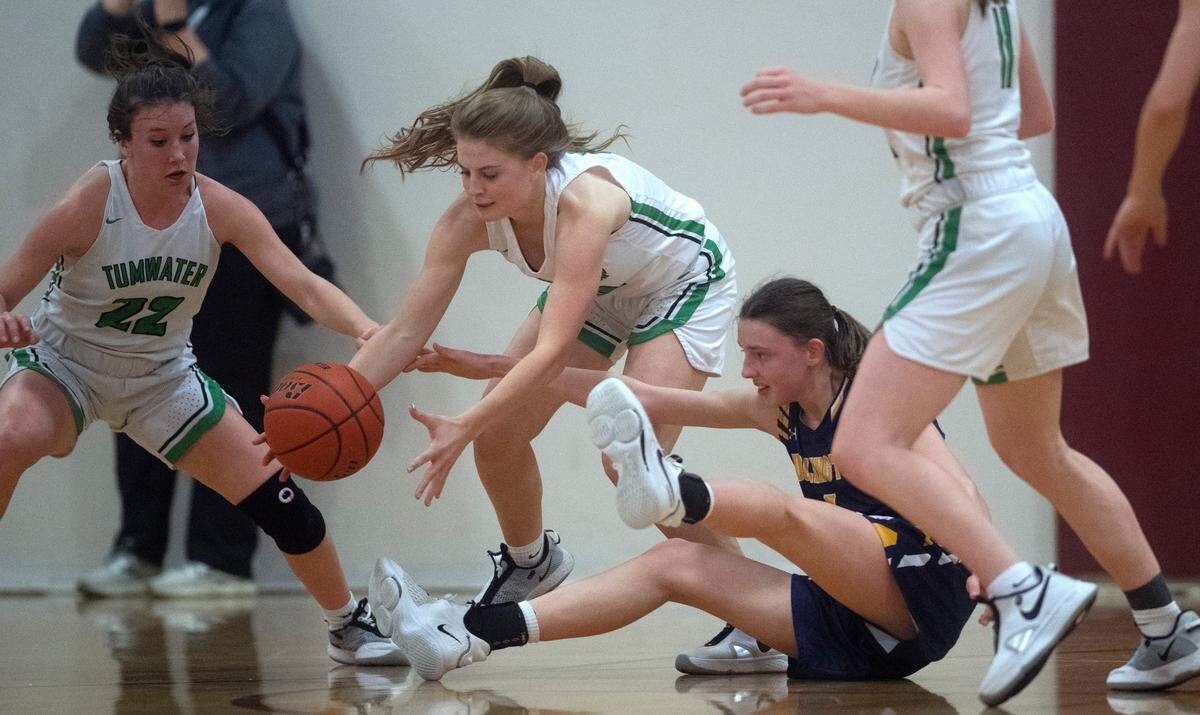 Tumwater’s Aly Waltermeyer steals the ball after forcing a turnover from Burlington-Edison’s Hannah Sayer during Saturday night’s 2A girls basketball state tournament regional-round game at WF West High School in Chehalis, Washington, on Feb. 26, 2022. Burlington-Edison won the game, 52-47.
