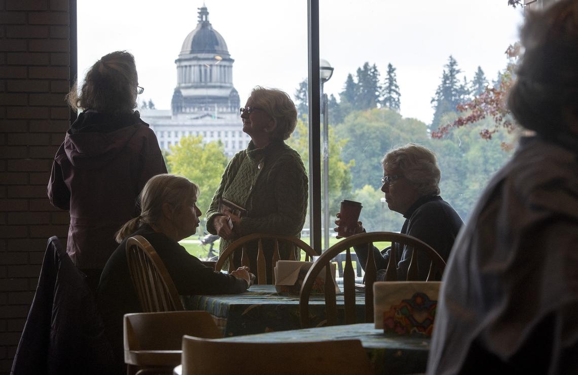 Customers gather for coffee and conversation in the shadow of the state Capitol at Traditions Fair Trade & Cafe in downtown Olympia.