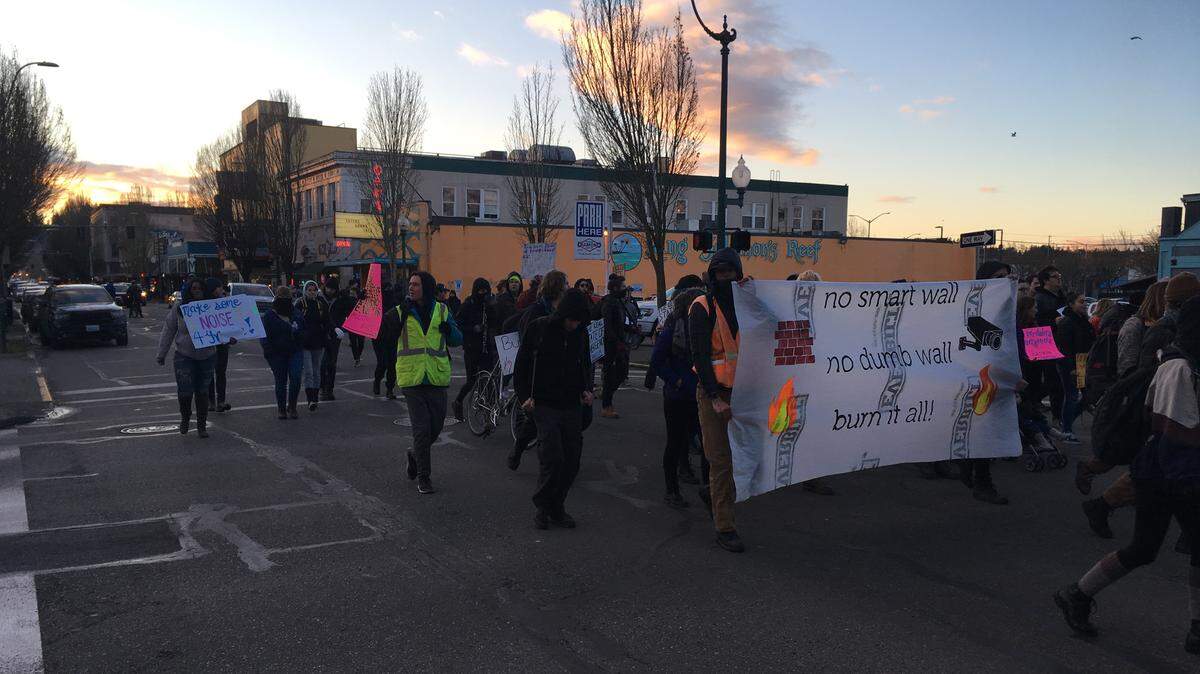 Between 50 and 100 people marched down Fourth Avenue Wednesday evening to protest the wall proposed by President Donald Trump for the U.S./Mexico border.