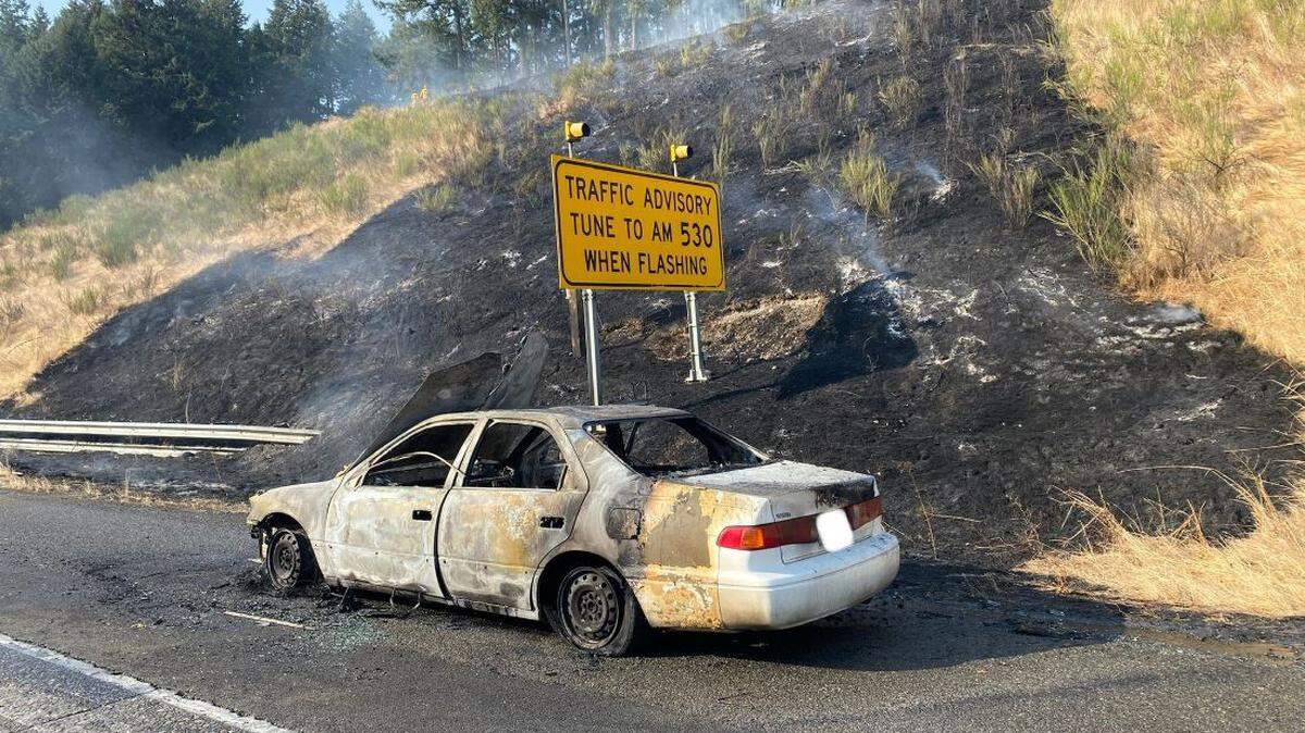 Southbound I-5 traffic was delayed about three hours Monday afternoon after a car caught fire and burned a hillside in Lacey, according to Washington State Patrol.