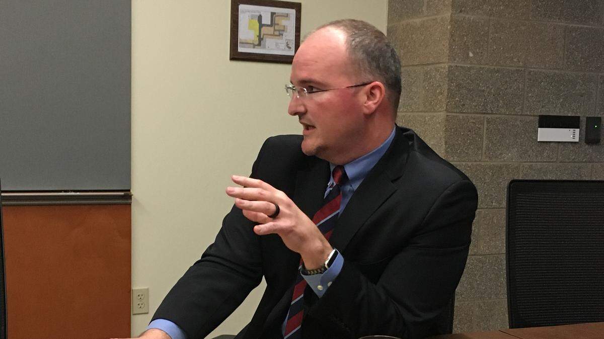 Lacey City Manager Scott Spence answers a question during a recent meeting with Lacey residents concerned about homeless camps in Hawks Prairie.