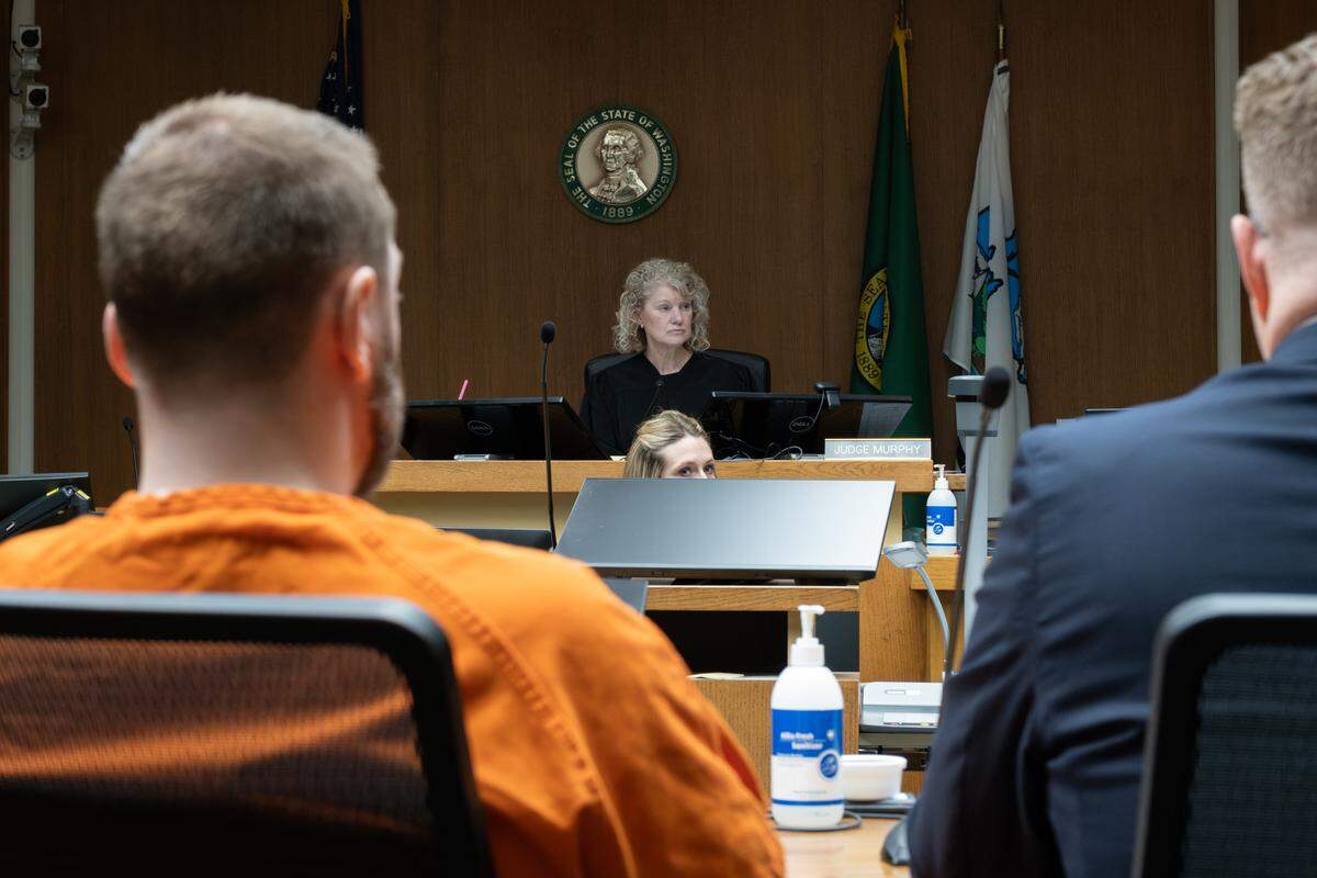 Nicholas Denham, 37, (left) looks to Thurston County Superior Court Judge Carol Murphy during his sentencing hearing on Thursday, Dec. 18, 2025. Murphy sentenced Denham to life in prison for killing a 34-year-old mother and her 4-year-old daughter in March 2020.