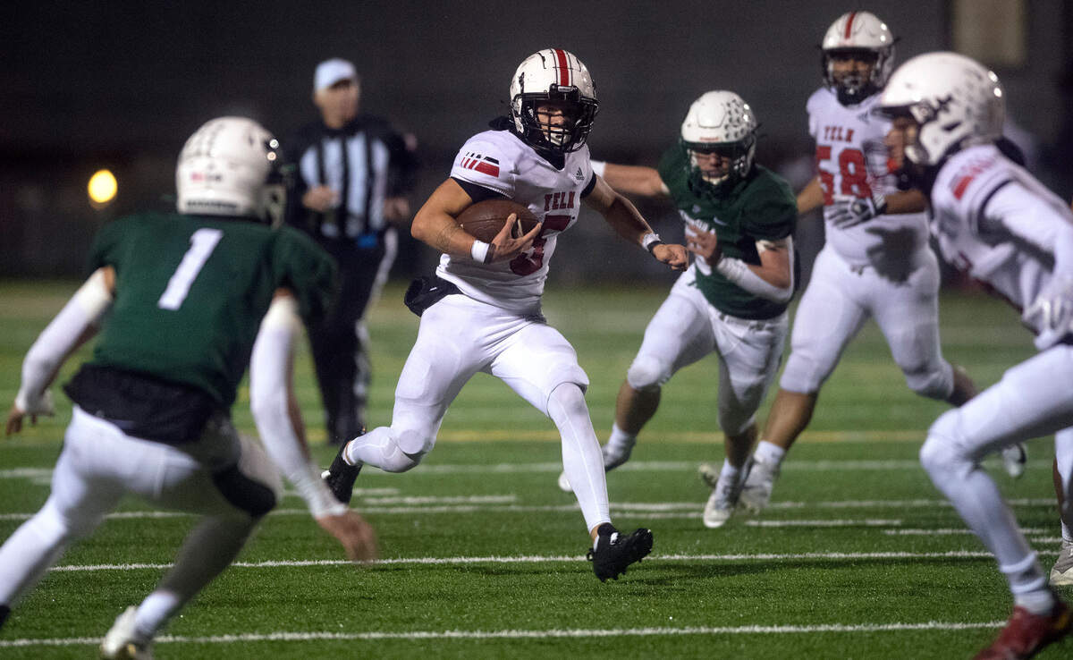 Yelm wide receiver Kyler Ronquillo looks to evade Peninsula defensive back Isaac Smith (1) during Friday night’s football game at Roy Anderson Field in Purdy, Washington, on Oct. 21, 2022.