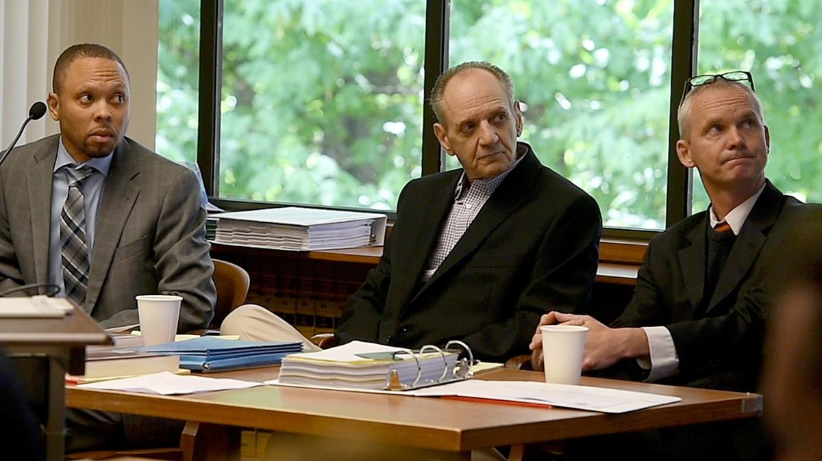 Flanked by his defense attorneys, Larry Jefferson (left) and Kevin Griffin, James Stidd views a projected image of Gail Doyle Wednesday during opening statements in his second-degree murder trial.