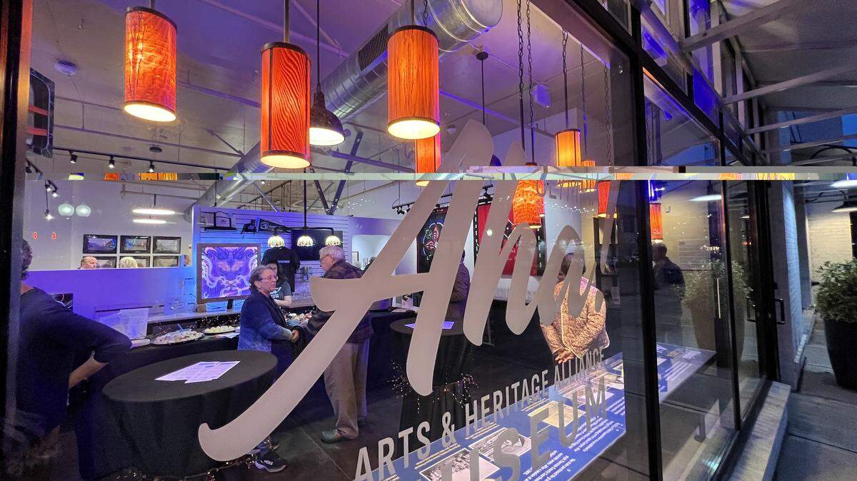 The Oly AHA Museum’s “Light the Dark” looks at light through contemporary art and local history. Hanging in the window is “Beneath the Bark,” a series of wood-veneer lamps by John Corzine.