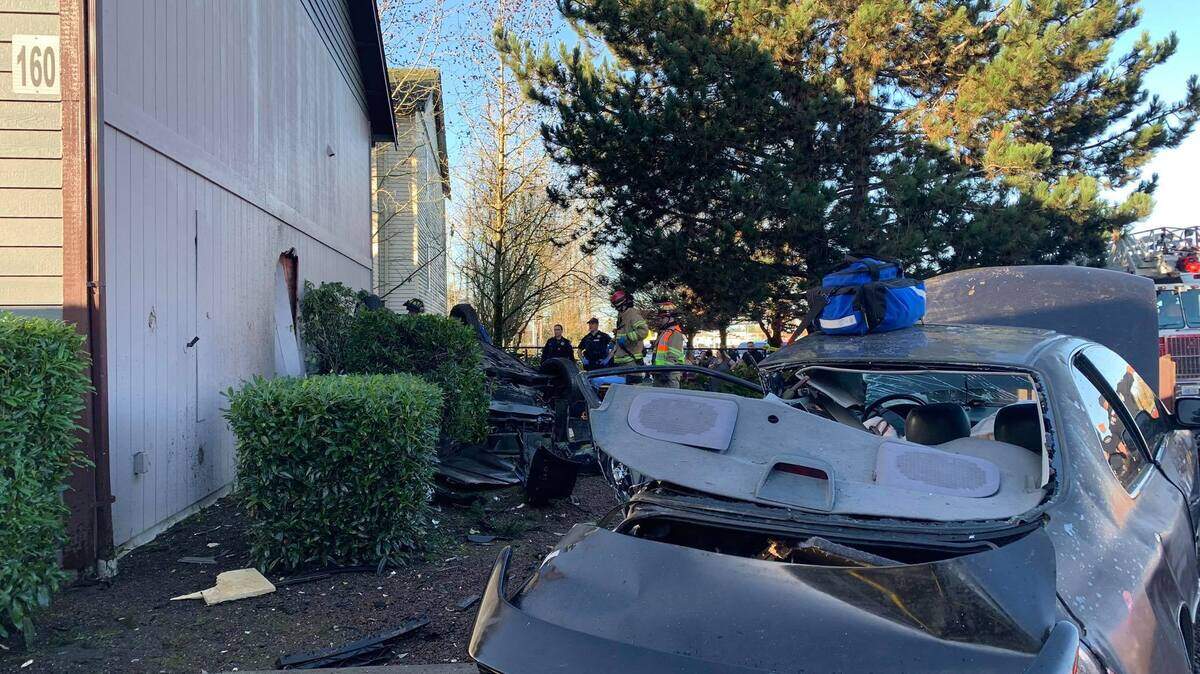 A two-car collision in Parkland Sunday morning closed a street in both directions and sent one vehicle into an apartment building, according to Central Pierce Fire & Rescue.