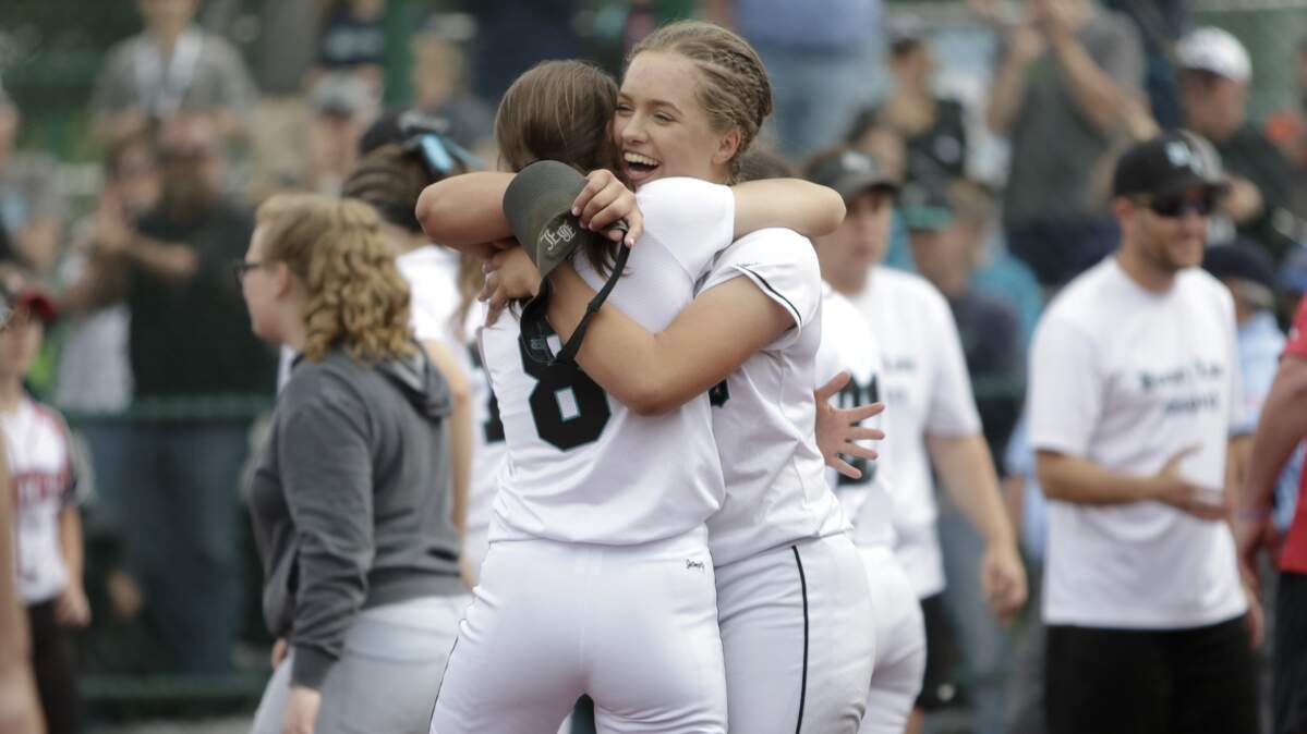 Bonney Lake's Gabby Jones (8) hugs pitcher Brooke Nelson after defeating Snohomish 8-5 in extra innings at the 3A state softball championship game on Saturday, May 26, 2018 at the Regional Athletic Complex in Lacey.