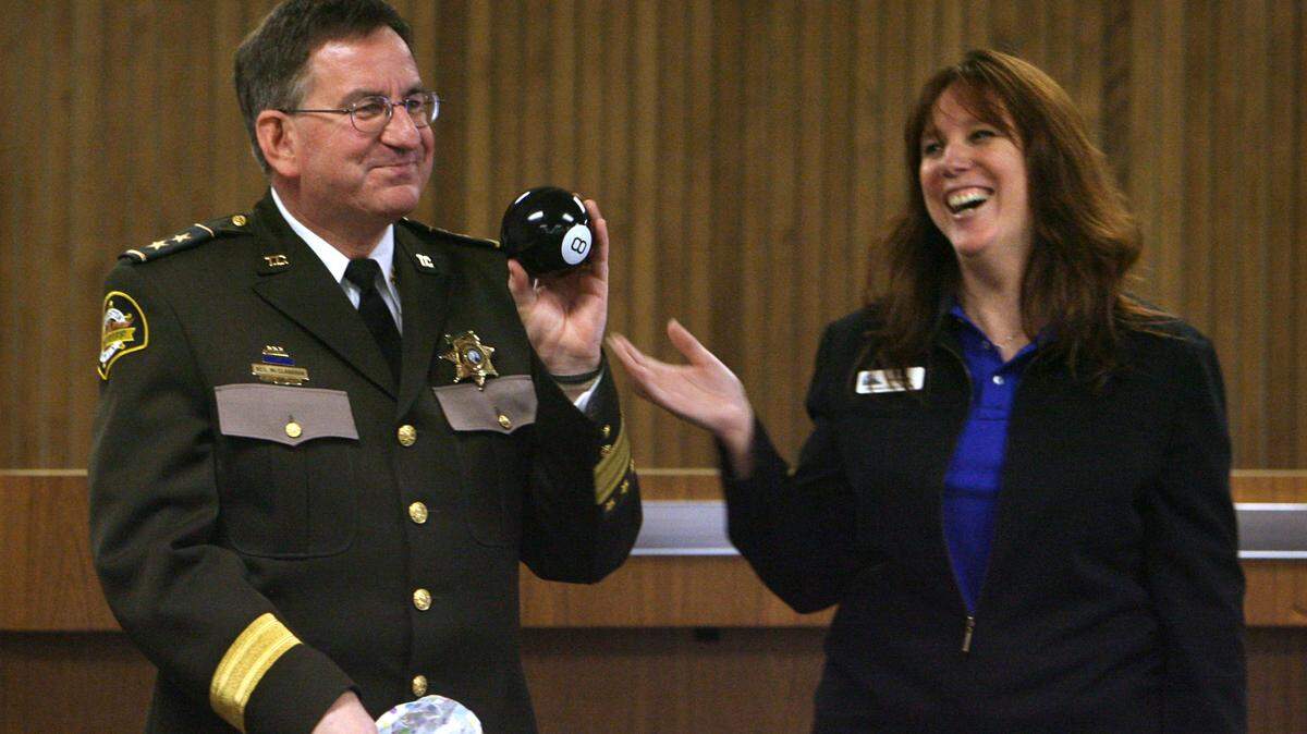 Neil McClanahan, Thurston County’s Undersheriff, receives a “Magic 8-Ball” from county Auditor Kim Wyman that she said would help him predict his future when he retired after more than 34 years with the Sheriff’s Office. McClanahan was honored by coworkers and friends during a reception at the Thurston County Courthouse when he retired in 2007.