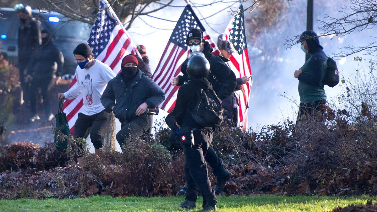 Supporters of President Donald Trump and antifa supporters clashed with state police, who used flash grenades and apparently tear gas used to break up disturbances on the state Capitol Campus in Olympia, Washington, on Saturday, Dec. 12, 2020.