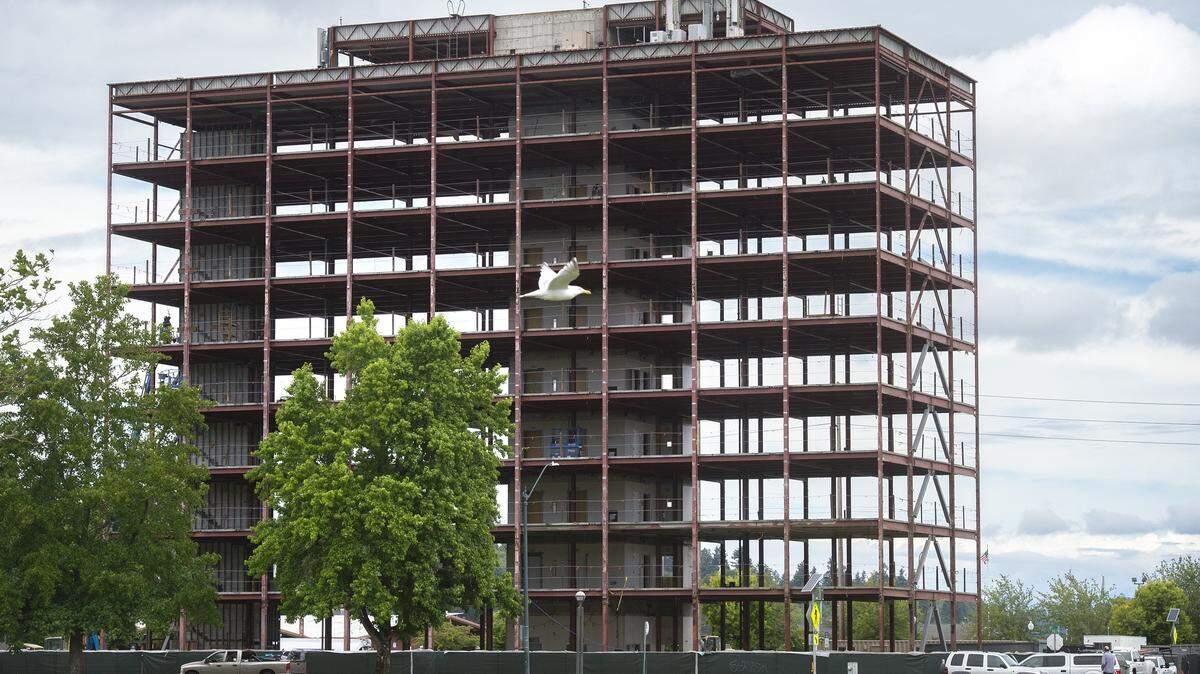 The Views on Fifth renovation project in downtown Olympia. In recent weeks, crews stripped the nine-story tower of its exterior, leaving the steel frame, elevator shaft and stairs.