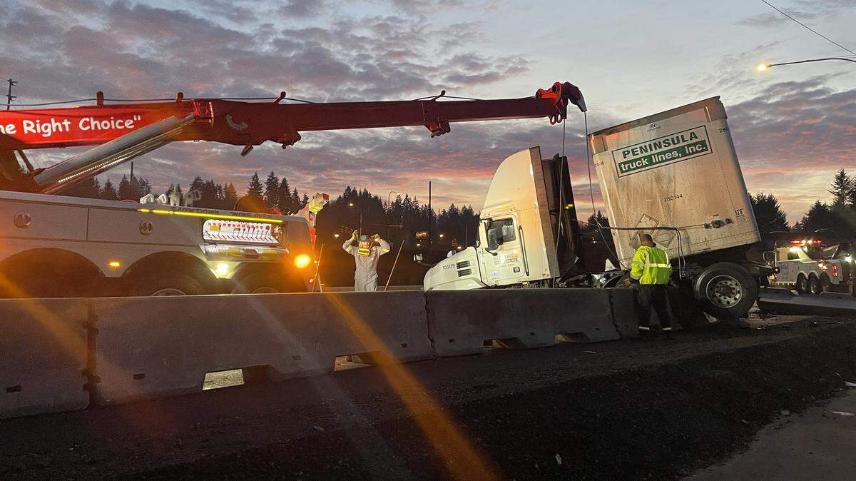 A crane helped remove the truck from the freeway barrier after a Friday morning crash on westbound state Route 16 near Port Orchard.