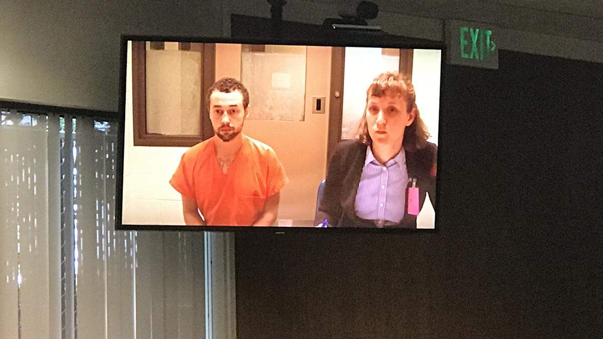 Terell L. D. Doyle, 24, sits alongside public defense attorney, Jenna Norden, during his preliminary appearance in Thurston County Superior Court on Thursday.