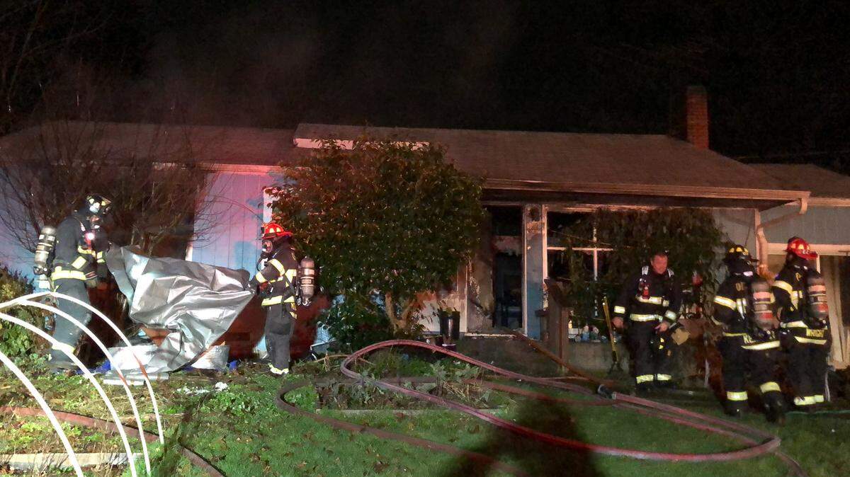 Olympia firefighters work on a house fire on the 400 Block of Frederick Street Northeast early Friday morning. All three occupants and a pet managed to escape the blaze with only one suffering minor burns, but the home had an estimated $200,000 in damage.