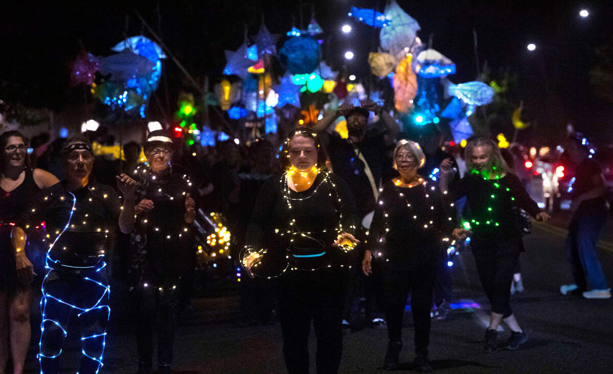Samba Olywa dancers lead the Luminary Procession down Capitol Way during the Fall Arts Walk in downtown Olympia, Washington, on Friday, Oct. 7, 2022.