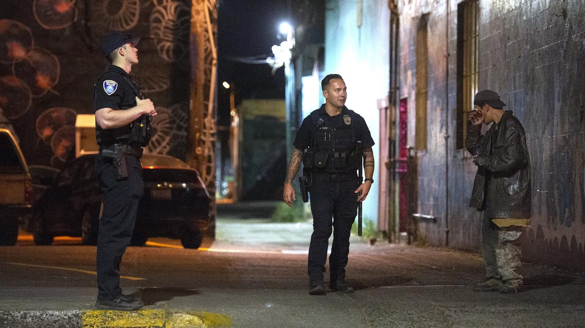 Olympia police officers Jordan Reisher (left) and Jacob Theis on their walking patrol of downtown Olympia on Friday, July 20, 2018.