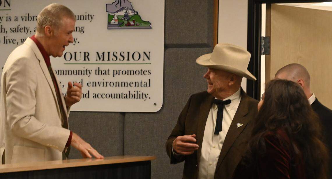 Outgoing Thurston County Commissioner Gary Edwards gets a some good natured ribbing from fellow Commissioner Ty Menser before joining other newly and re-elected officials during the Dec 17, 2024 ceremony at the Atrium building in Olympia which houses county services. ...