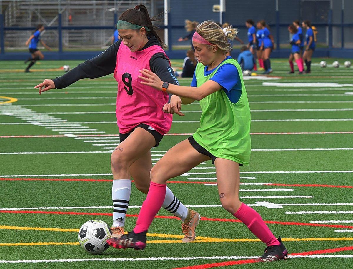 Bears’ Katelyn Rigg (left) and Lyv Heistand battle for the ball during Olympia’s Oct. 20 practice.