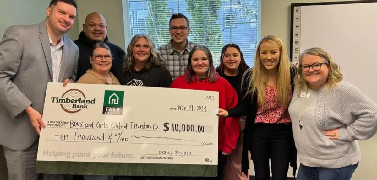 Members of the Boys and Girls Club of Thurston County with a $10,000 check from Timberland Bank and the Federal Home Loan Bank of Des Moines.