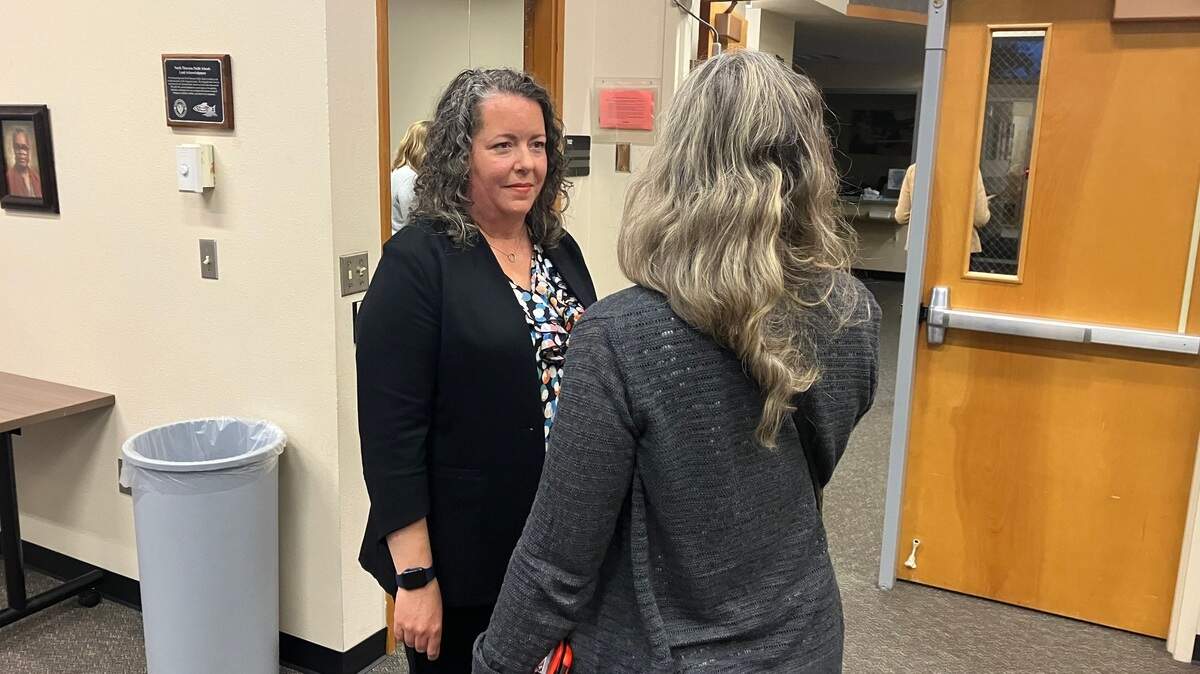 New District 3 school director Sarah Tracy chats with board member Tiffany Sevruk following Tuesday’s North Thurston Public Schools board meeting.
