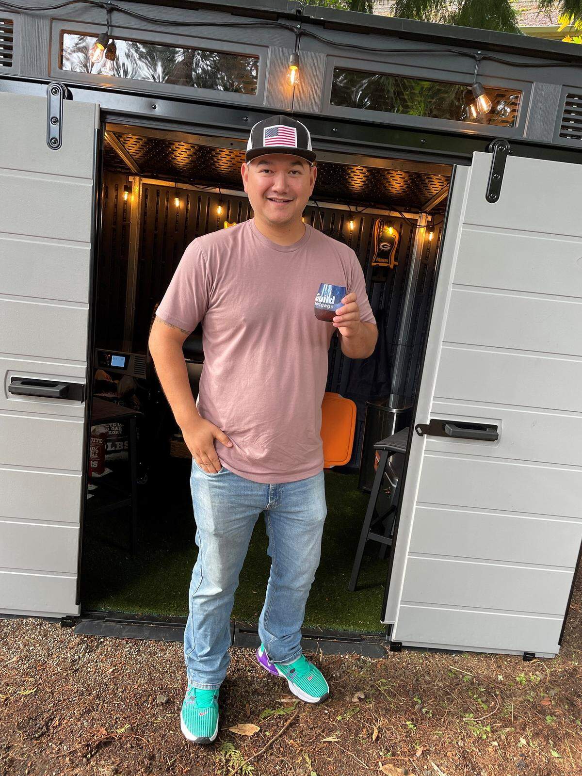 Fundraiser recipient Jeff Mendiola standing in front of the shed and meat smoker he recently received.