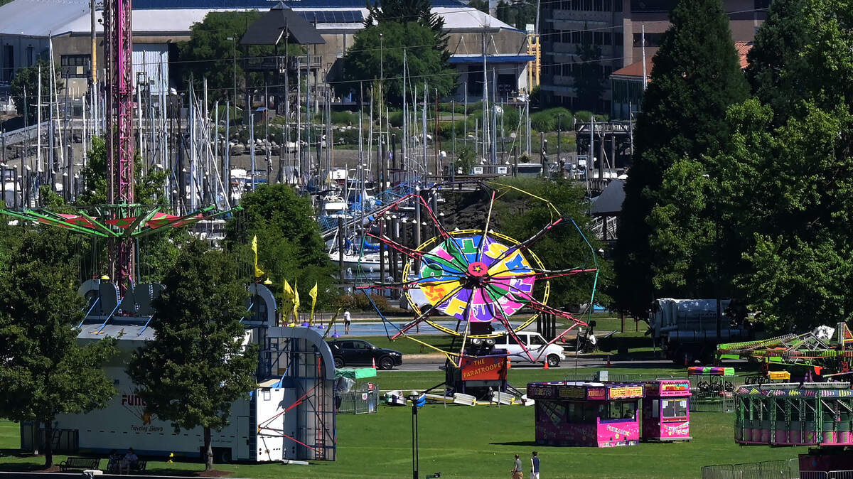 Funtastic Traveling Shows finishes installing their amusement rides and booths in Heritage Park along Capitol Lake in preparation for 2022 Capital Lakefair.