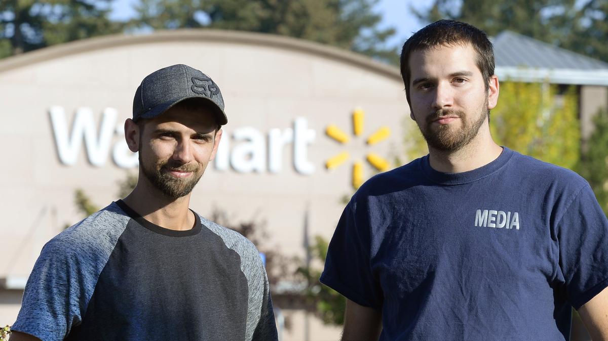 Kyle and Tyler Fievez stand near the Tumwater Walmart where their father, Rickey Fievez, was shot during an attempted carjacking in the store’s parking lot in June.