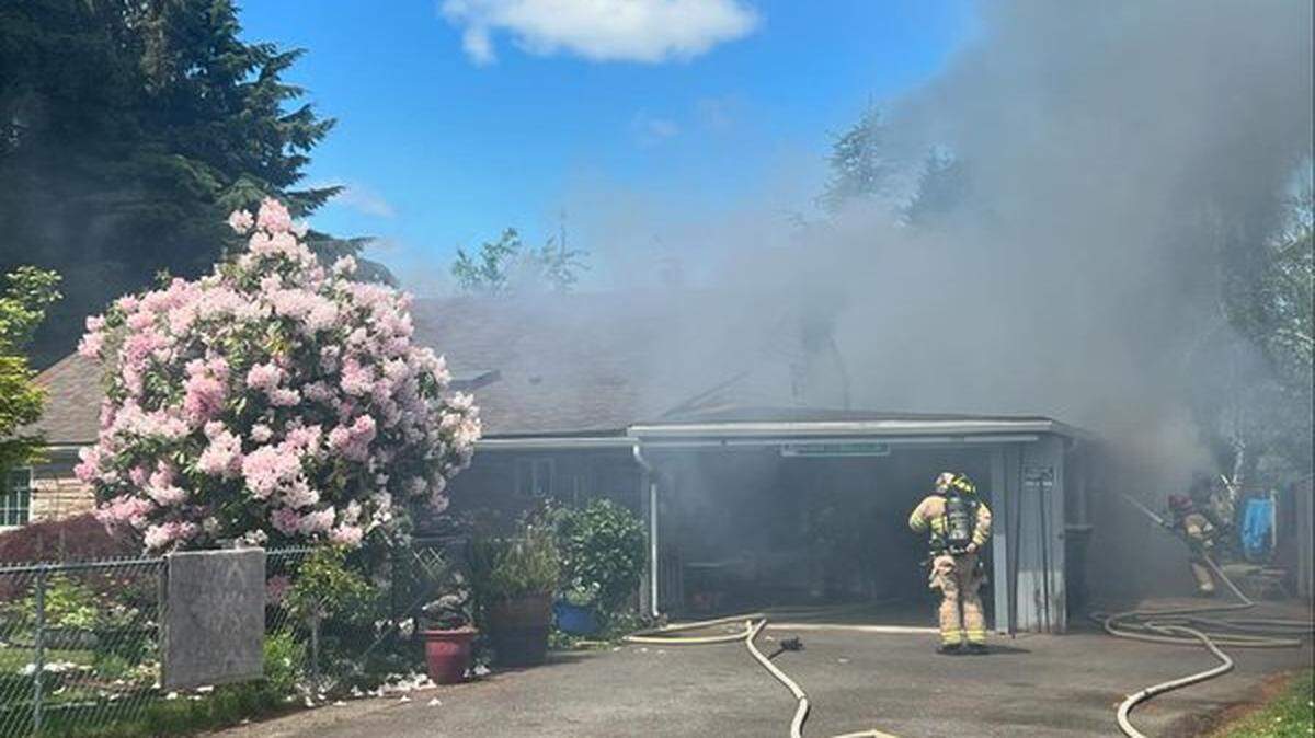 Lacey fire crews extinguish a house fire in the 4700 block of 14th Avenue Southeast on May 19.