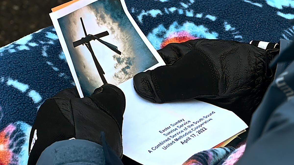 A church member holds a program for the sunrise Easter service presented by the South Sound United Methodist Cooperative on April 17, 2022.