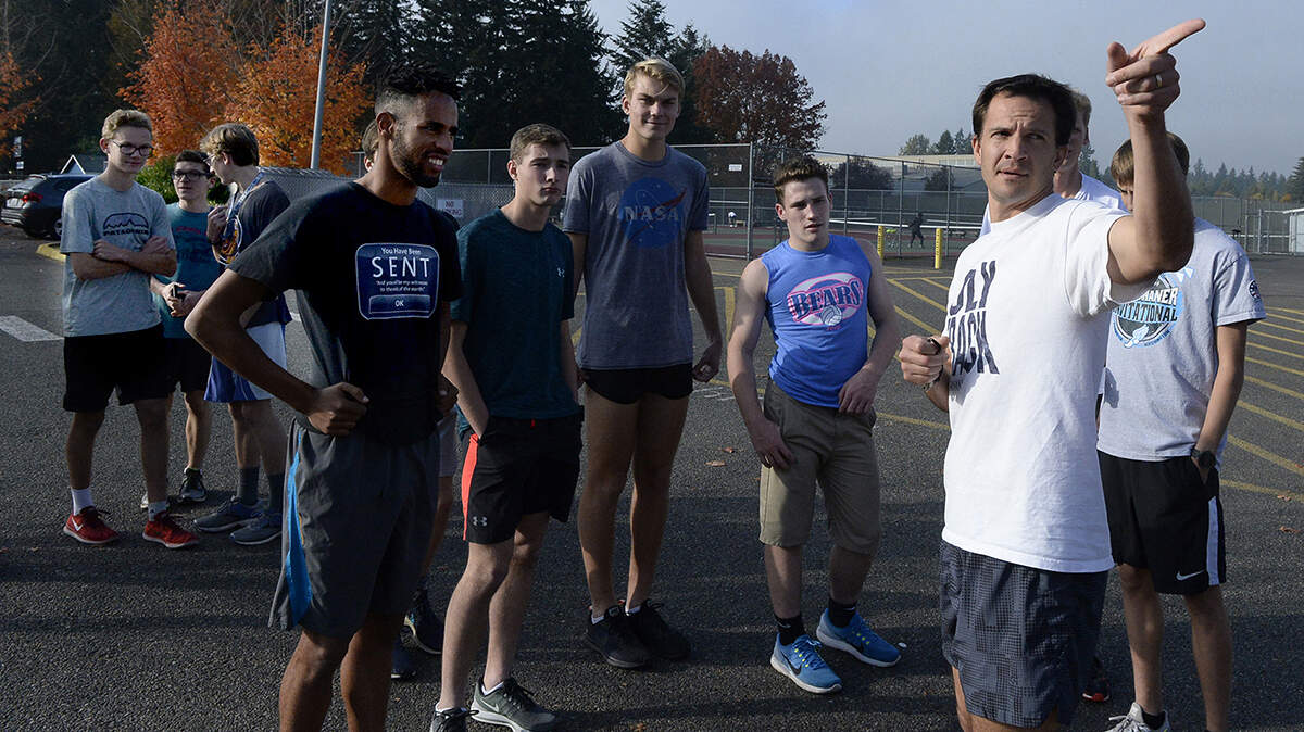 Olympia boys cross country team head coach Jesse Stevick gets his team set for their Monday practice run after the Bears grabbed the 4A SPSL title last last week.