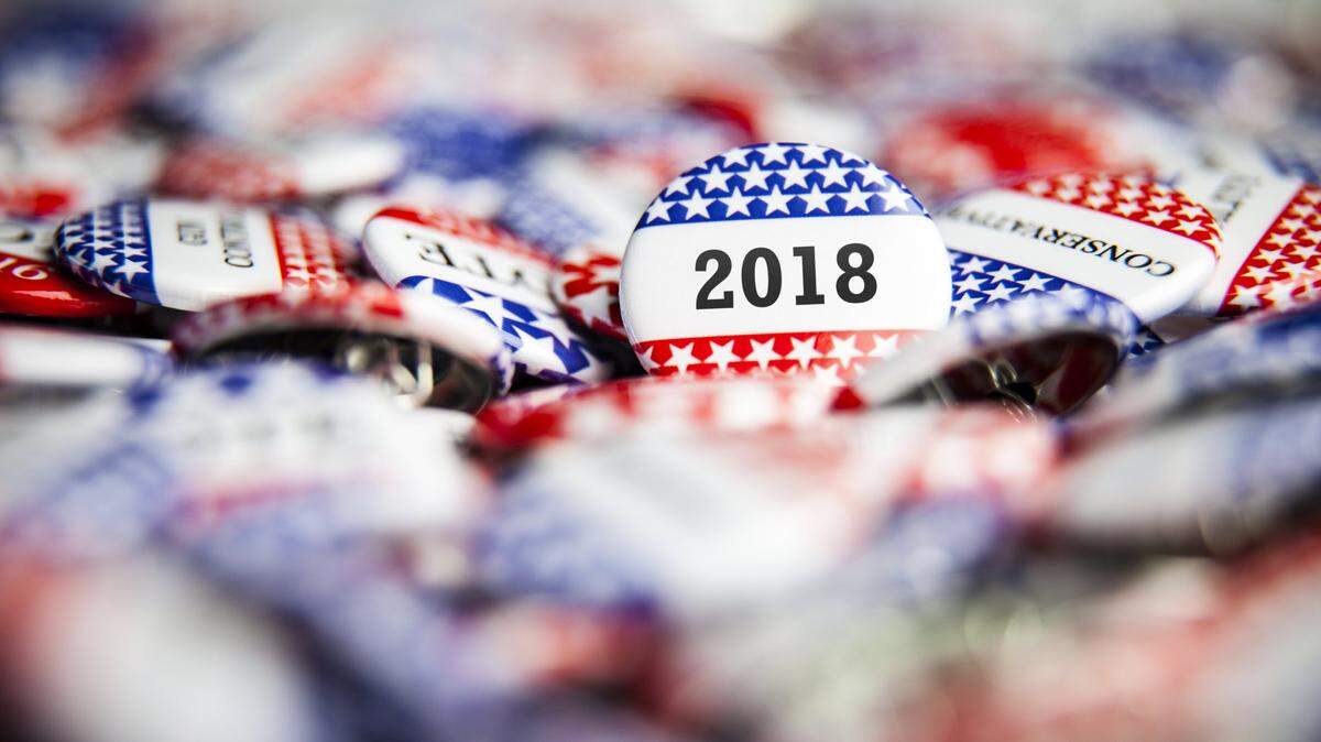 A 2018 Election Vote button on a pile of other buttons