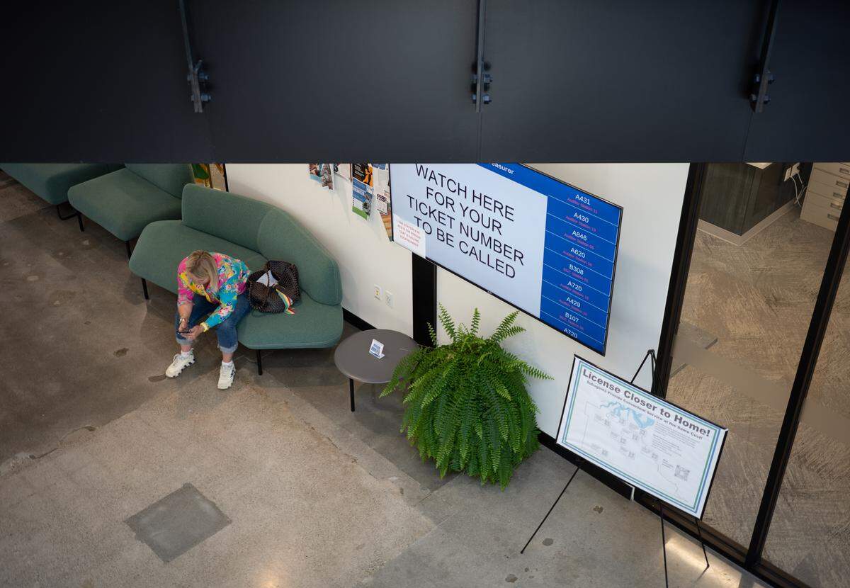 A person waits outside the Thurston County Auditor’s Office at The Atrium, the county’s administrative headquarters, on Friday, Sept. 19, 2025. The Atrium is at 3000 Pacific Ave. SE in Olympia. The Auditor’s Office handles county elections and voter registration as well as provides recording, licensing and passport services to the public.