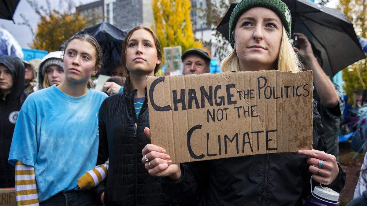 Willamette University student Arabella Wood, right, gathers with others at a rally in Eugene, Ore., on Oct. 29, 2018, to support a high-profile climate change lawsuit brought by 21 young people against the federal government. Trial was set to begin in federal court in Eugene on Monday morning. But the U.S. Supreme Court temporarily halted the proceedings to decide whether the case should move forward.