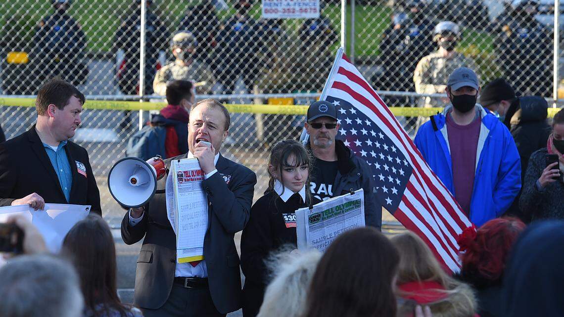 Joined by his daughter Riley (right), Tim Eyman addresses a crowd of around 100 near the Winged Victory Monument on the Capitol Campus in Olympia on Sunday. The Olympia Freedom Party gathering lasted about an hour.
