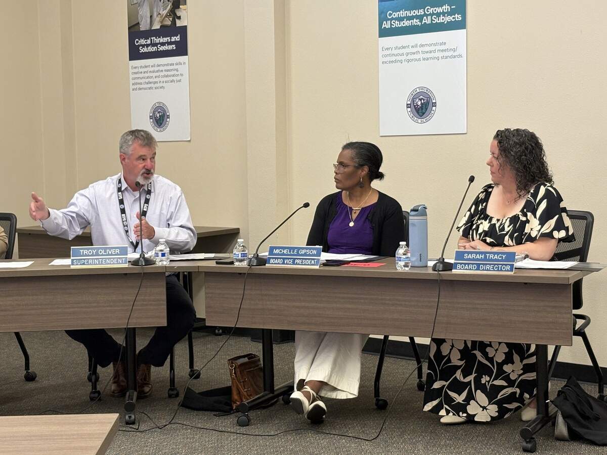 North Thurston Superintendent Troy Oliver (left) answers a question during Tuesday’s school board meeting as school directors Michelle Gipson (center) and Sarah Tracy listen.