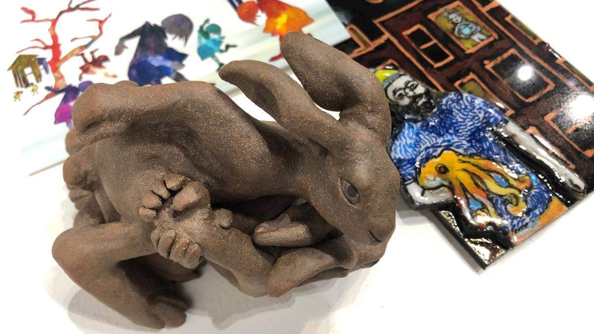 Three of the 247 works in this year’s “While You Were Out” postcard art show at SPSCC: Joe Batt’s rabbits wrestling, Liza Brenner-Samples’ octopus guy, and Ruth Bravetti’s children playing.