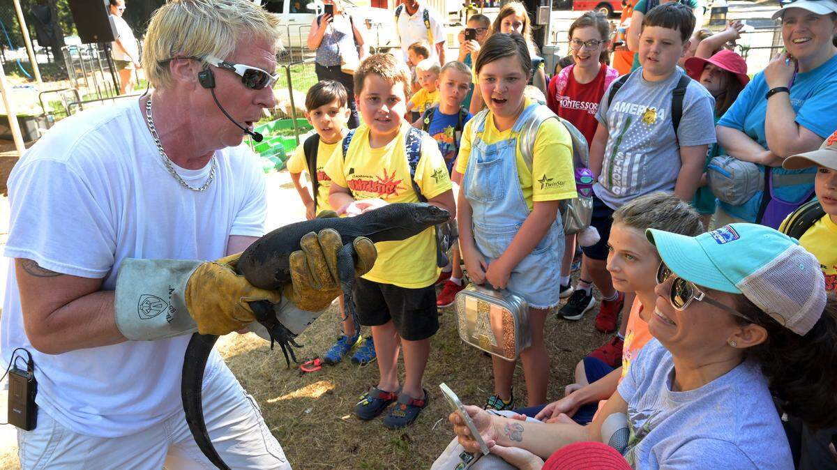 Don “The Reptile King” Riggs introduces his young Komodo dragon “Toothless” to a surprised audience on the Thurston County Fair’s 2022 opening day, July 27.