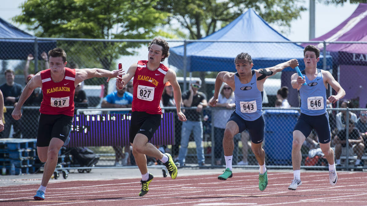 Jurrian Hering of Gig Harbor receives the baton in the 3A boys 4x100 relay prelims at the 4A/3A/2A track and field state championships at Mount Tahoma High School in Tacoma on Friday, May 25, 2018.