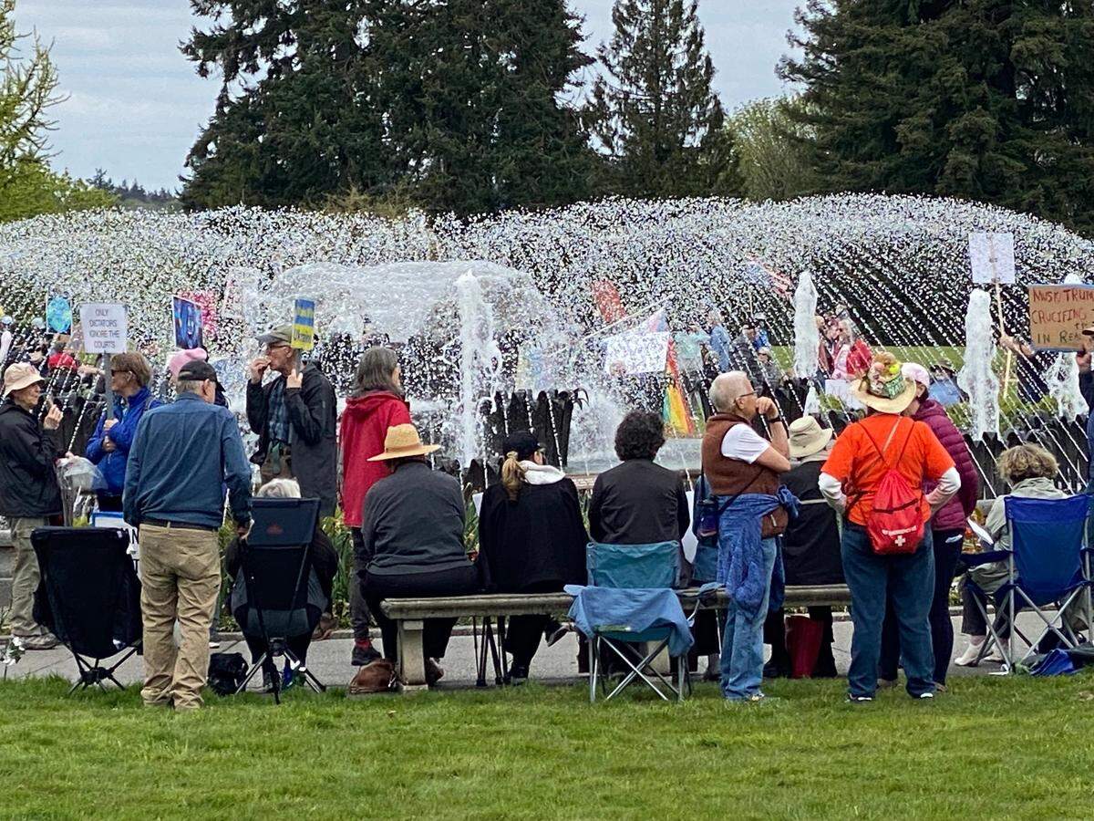 Protesters take a rest around Tivoli Fountain on the Capitol Campus Saturday, April 19, 2025.