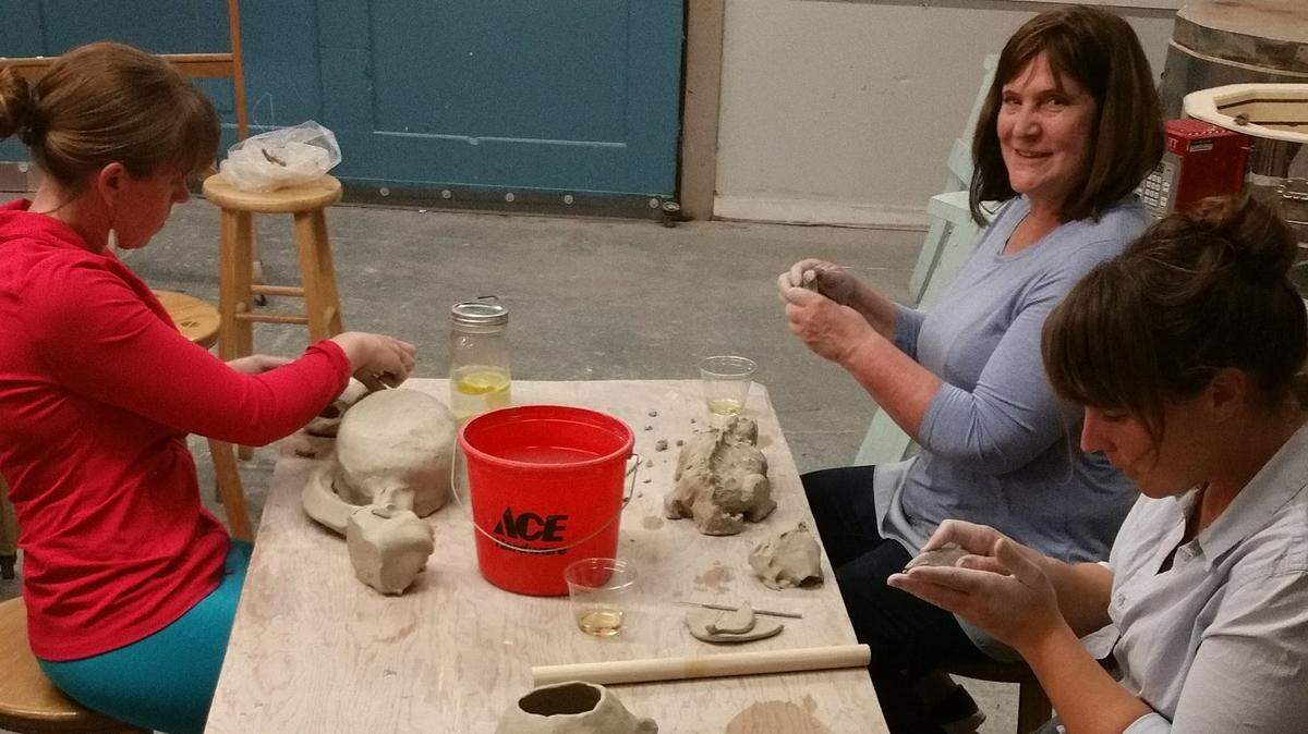 Students get their hands dirty during a Play with Clay class.